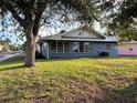 Home's rear elevation, showcasing a large grassy backyard at 627 Palm Ave, Punta Gorda, FL 33950