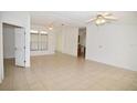 Bright living room with tile floors and ceiling fans at 12415 Catalina Dr, Punta Gorda, FL 33955