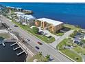 Aerial view showcasing condo building's waterfront location and road access at 1601 Park Beach Cir # 112/2, Punta Gorda, FL 33950