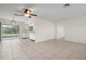 Open living and dining area with tile flooring and kitchen access at 1713 Belvidere Rd, Englewood, FL 34223