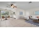 Open living and dining area with tile flooring and kitchen access at 1713 Belvidere Rd, Englewood, FL 34223