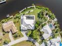 Bird's-eye view of home, showcasing waterfront location and pool at 18138 Petoskey Cir, Port Charlotte, FL 33948