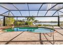 Relaxing pool area with screened enclosure and water views at 18138 Petoskey Cir, Port Charlotte, FL 33948