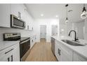 Modern kitchen featuring white cabinets, stainless steel appliances, and a large island at 2332 Brown St, Port Charlotte, FL 33948