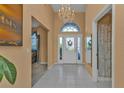 Bright and airy foyer with tile flooring and a half bathroom at 24088 Buckingham Way, Punta Gorda, FL 33980