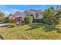 Single-story house with lush landscaping and attractive curb appeal at 24088 Buckingham Way, Punta Gorda, FL 33980