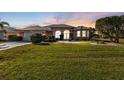 Well maintained single story home with a metal roof, and a neatly landscaped lawn at 26081 Templar Ln, Punta Gorda, FL 33983