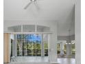 Bright living room with large sliding glass doors leading to a screened patio at 3116 Silkwood Ln, Port Charlotte, FL 33953