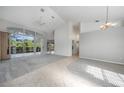 Spacious living room with high ceilings, tile and carpet flooring, and sliding glass doors at 3116 Silkwood Ln, Port Charlotte, FL 33953