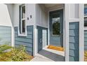 Modern front door with a glass panel and a welcome mat at 438 Leona St, Port Charlotte, FL 33954