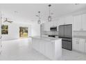 Modern kitchen featuring white cabinets, stainless steel appliances, and an island at 438 Leona St, Port Charlotte, FL 33954