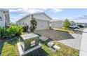 View of the home's electrical box and paved driveway at 44197 Frontier Dr, Punta Gorda, FL 33982