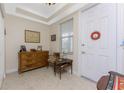 Bright and airy entryway with tiled floors and wooden furniture at 5116 Melbourne St # B201, Punta Gorda, FL 33980