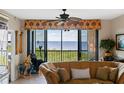 Living room with water views and comfortable seating at 900 E Marion Ave # 1403, Punta Gorda, FL 33950