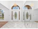 Bright entryway with double doors and mirrored wall at 1160 Rizzo St, Port Charlotte, FL 33952