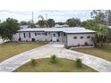 Charming one-story home featuring a well-maintained yard, updated paint, and a circular driveway at 22143 Lasalle Rd, Port Charlotte, FL 33952
