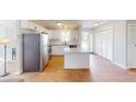 Modern kitchen featuring white cabinetry, stainless steel appliances, and an island with counter seating at 22143 Lasalle Rd, Port Charlotte, FL 33952