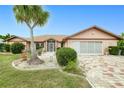 Charming single-story home featuring a mature palm tree and a well-maintained lawn at 2259 Kenya Ln, Punta Gorda, FL 33983