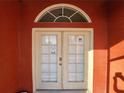 Double front doors with arched window, leading into the house at 23104 Rountree Ave, Port Charlotte, FL 33980