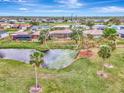 Property view showcasing the house and surrounding landscape at 24 Oakland Hills Ct, Rotonda West, FL 33947
