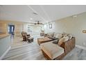 Living room with L-shaped sectional sofa and hardwood floors at 3355 Elkcam Blvd, Port Charlotte, FL 33952