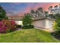 Charming house with lush landscaping, visible at dusk at 4650 Eldron Ave, North Port, FL 34286