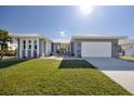Beautiful house with gray exterior, white trim, and a two-car garage at 525 Madrid Blvd, Punta Gorda, FL 33950
