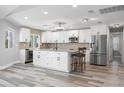 Modern kitchen with white cabinets, granite countertops, and stainless steel appliances at 525 Madrid Blvd, Punta Gorda, FL 33950
