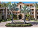 Attractive building entrance with palm trees and landscaping at 87 Vivante Blvd # 8736, Punta Gorda, FL 33950