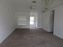 Spacious living room featuring neutral carpeting and ample natural light at 1073 Marcus St, Port Charlotte, FL 33952