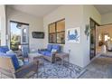 Relaxing screened patio with wicker furniture and a rug at 1656 Hyssop Loop, North Port, FL 34289