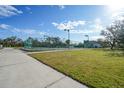 Private tennis court with green surface and surrounding fence at 1931 Bayshore Dr, Englewood, FL 34223