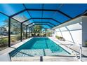 Refreshing screened-in pool with ample space for relaxation at 24490 Wallaby Ln, Punta Gorda, FL 33955