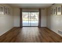 Bright living room with wood floors and sliding doors leading to the pool area at 3202 Meadow Run Dr, Venice, FL 34293