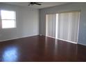 Simple bedroom with hardwood floors and a window with blinds at 6363 Sooner St, North Port, FL 34287