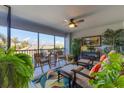 Spacious screened balcony with seating and tropical plants at 14070 Heritage Landing Blvd # 423, Punta Gorda, FL 33955