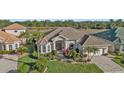 Luxury home with tile roof and lush landscaping at 2163 Silver Palm Rd, North Port, FL 34288