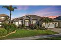 Luxury home exterior at dusk showcasing its curb appeal at 2163 Silver Palm Rd, North Port, FL 34288