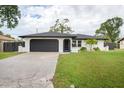 Newly renovated home with a freshly painted exterior and manicured lawn at 340 Carmel Rd, Venice, FL 34293