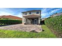 Spacious backyard with a brick patio and screened enclosure at 4261 River Bank Way, Punta Gorda, FL 33980