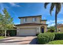 Two-story house with a two-car garage and manicured lawn at 4261 River Bank Way, Punta Gorda, FL 33980