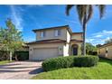 Two-story house with a two-car garage and manicured lawn at 4261 River Bank Way, Punta Gorda, FL 33980