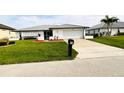 Front view of a single-story house with a garage at 68 Colony Point Dr, Punta Gorda, FL 33950