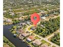 Waterfront property with canal access, lush landscaping, and proximity to amenities at 13707 Begonia Cir, Port Charlotte, FL 33981