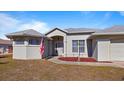 Charming single-story home featuring a well-manicured lawn and a welcoming front entrance at 17220 Horizon Ln, Port Charlotte, FL 33948