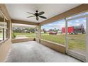 Spacious screened porch features a ceiling fan and views of the yard at 30087 Alder Rd, Punta Gorda, FL 33982