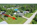From above, a property nestled among lush greenery showcases a well-maintained lawn and neighborhood at 4363 Sansedro St, Port Charlotte, FL 33948