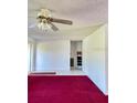 Spacious living room featuring tile flooring and a bright ceiling fan at 4363 Sansedro St, Port Charlotte, FL 33948