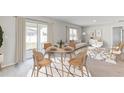 Bright living room featuring an open floor plan, modern furniture, and a sliding glass door to the yard at 5481 Burgner St, Port Charlotte, FL 33981