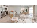 Bright living room featuring an open floor plan, modern furniture, and a kitchen with a breakfast bar at 5481 Burgner St, Port Charlotte, FL 33981